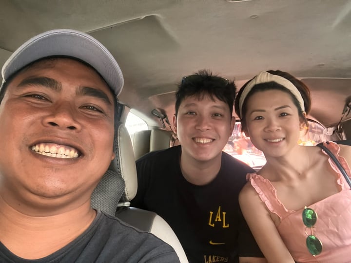 Asian couple in a selfie with Komang Mamo in the car