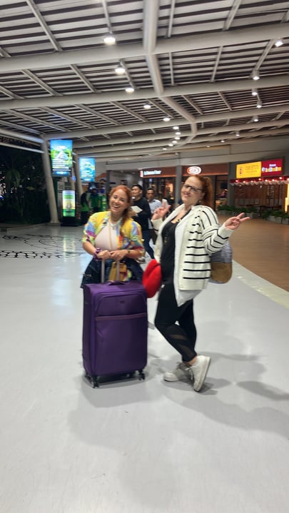 Two girls posing at Bali Airport